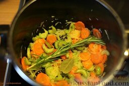 Суп фасолевый с томатами: В кастрюле с толстым дном обжарить на оливковом масле лук (5 минут).  Затем добавить морковь, сельдерей, веточку розмарина и лавровый лист.