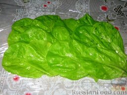 Салат-рулет с ветчиной: На пищевой пленке выложим листья салата.