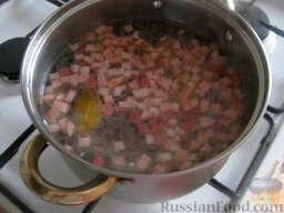 Солянка с колбасой: Когда вода вскипит, выложить колбасу.