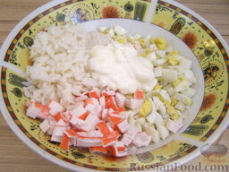 Кальмары, фаршированные крабовым салатом: Соединить рис, крабовые палочки и яйца. Добавить 2 ст. ложки майонеза и тщательно перемешать.