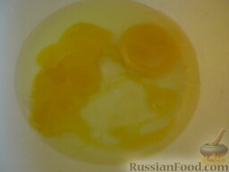 Оладьи с черносливом: В миску разбить куриные яйца.