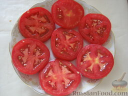 Помидоры "под шубой": Выложить половину помидоров на блюдо.