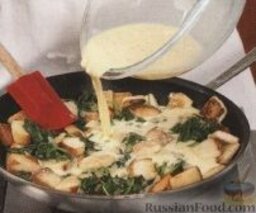 Страта с крутонами, шпинатом и фетой: 4. Ввести в сковороду шпинат с луком и залить яичной смесью.