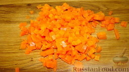 Салат Оливье: Отварить морковь, остудить, очистить, нарезать мелкими кубиками.