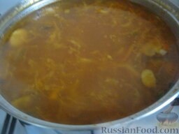 Солянка с капустой, грибами и консервированной рыбой: Выложить в суп зажарку и рыбу. Посолить, поперчить, добавить лавровый лист. Варить под крышкой 5 минут.