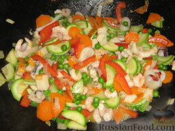 Лапша соевая с овощами и морепродуктами: Креветки, каракатицы и крабовые палочки помещаем на сковороду к овощами и тоже обжариваем.