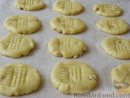 Медовое печенье с арахисом: Выложить медовое печенье на противень, накрытый пергаментом, вилкой выдавить узор в виде 