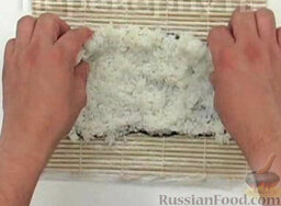Роллы Хура-маки: Смочить руки в воде с уксусом.  Рис равномерно, слегка приминая, распределить на листе нори, на циновке макису (обернутой пищевой пленкой).