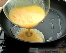 Морковный омлет: Вылить на сковороду треть взбитых яйц.