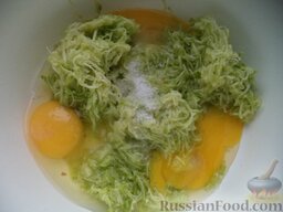 Кабачковые оладушки "От бабушки": Выложить кабачок в миску. Добавить яйца. Посолить.