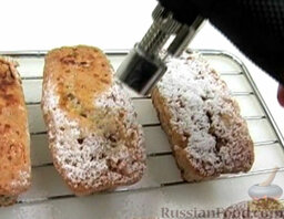 Кексы с грецкими орехами (а-ля французские тосты): Посыпать кексы с грецкими орехами сахарной пудрой. Расплавить пудру кулинарной газовой горелкой (по возможности).