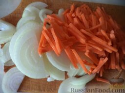 Жаркое из свиной грудинки с помидорами: Очистить и помыть лук и морковь. Лук нарезать полукольцами. Морковь нарезать тонкой соломкой.