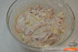 Запеченная курица с картошкой: Как приготовить запеченную курицу с картошкой:    Чеснок измельчить ножом. Лук порезать дольками.  Натереть куриные бедра специями и солью. Заправить сметаной, луком и чесноком, перемешать. Отставить в сторону.