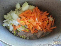 Рагу с индюшатиной и спаржевой фасолью: В поджаренное мясо всыпаются лук и морковь. Предварительно лук нарезается кубиками, а морковь - соломкой.