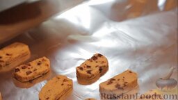 Печенье с кусочками шоколада: На противень постелить бумагу для выпекания (или фольгу) и выложить на нее печенье, слегка придавив каждое посередине.
