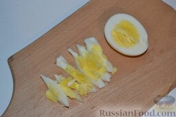 Салат из кальмаров с грибами: Отвариваем куриные яйца вкрутую. Охладив вареные яйца в холодной воде и очистив от скорлупы, нарезаем на дольки.