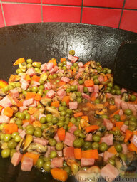 Жареный рис по-янчжоуски: Дальше зелёный горошек. И тут же добавляем в столовую ложку сахара, немного соли, все соусы и масла. Перемешиваем пару минут.