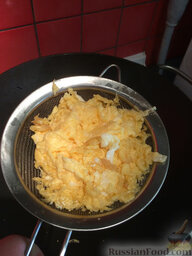 Жареный рис по-янчжоуски: Аккуратно вынимаем болтунью, избавляясь от лишнего масла.