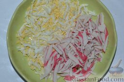 Салат из крабовых палочек: Размороженные крабовые палочки нарезаю соломкой, добавляю их к натёртым куриным яйцам.
