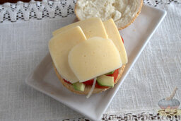 Бургер домашний, с авокадо и чили: Покрываем заготовку для бутерброда твердым сыром.