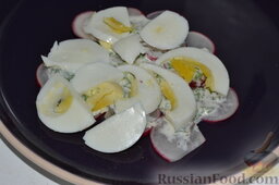 Салат из редиски с яйцом: Следующий слой - нарезанные дольки яиц.