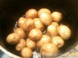 Молодой картофель, жаренный с чесноком и укропом: В казанке разогреть растительное масло. Выложить подготовленный картофель. Перемешать его с маслом.